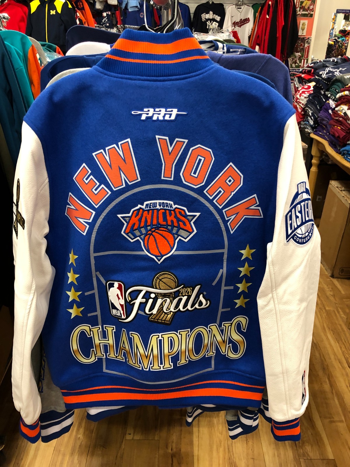 NEW YORK KNICKS 2026 NBA CHAMPIONS MENS ROYAL BLUE VARSITY JACKET