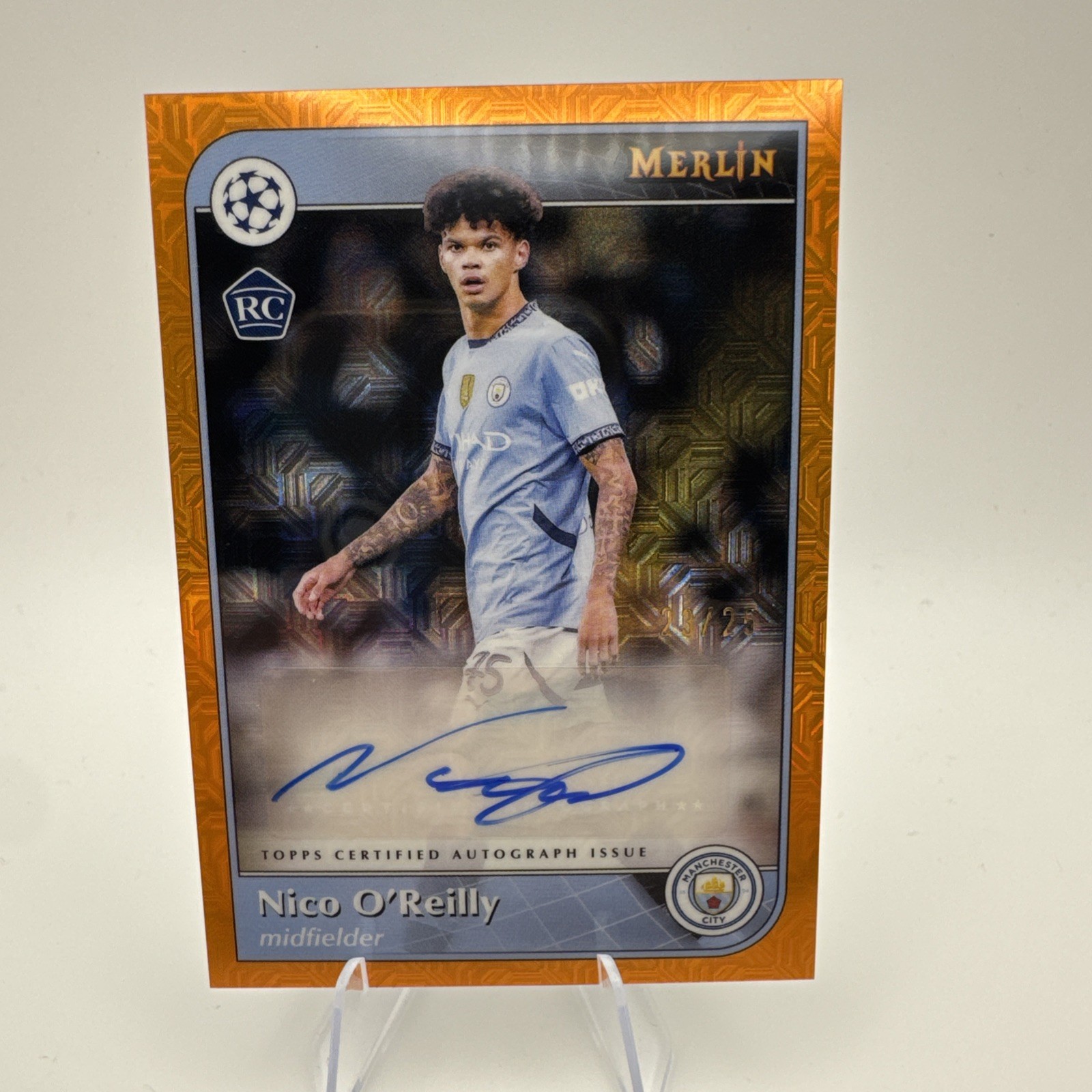 2024-25 Uefa Club Competitions – Autographs Nico O’Reilly /25 Orange Mojo
